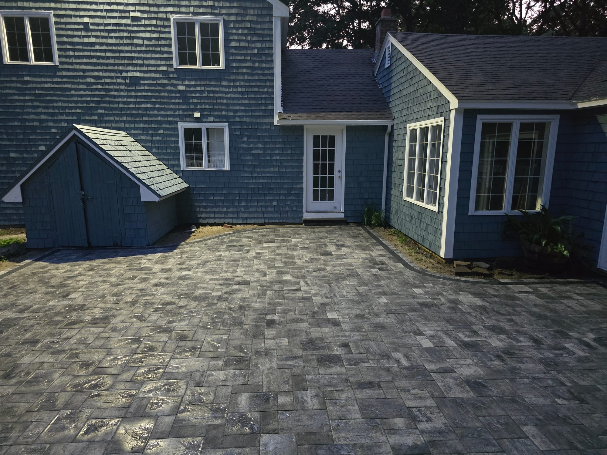 Backyard patio with a matching storage shed