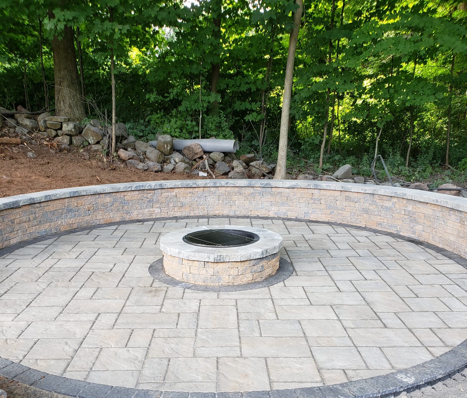 Circular fire pit patio with a curved sitting wall