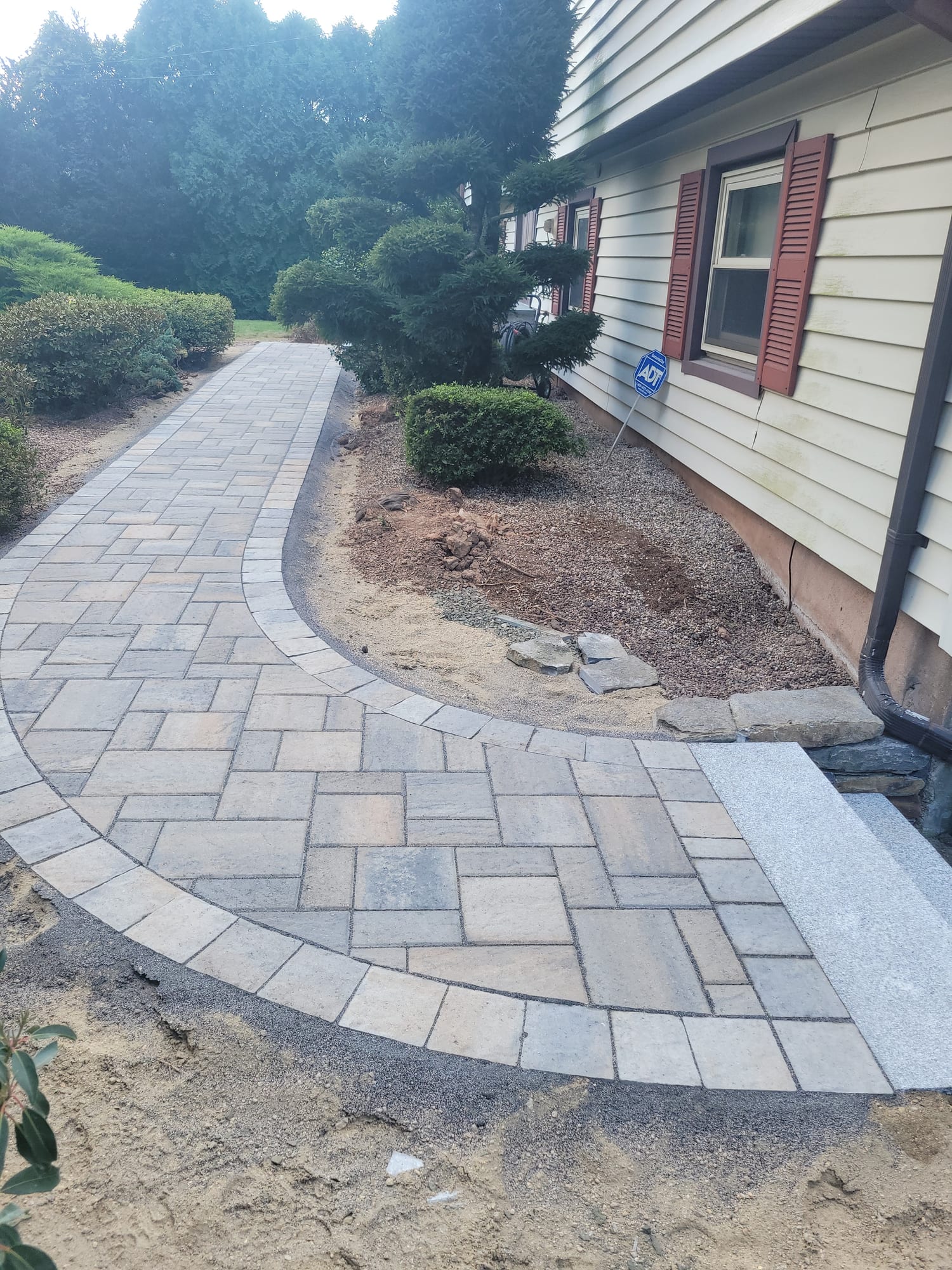 Curved side walkway with a granite step landing