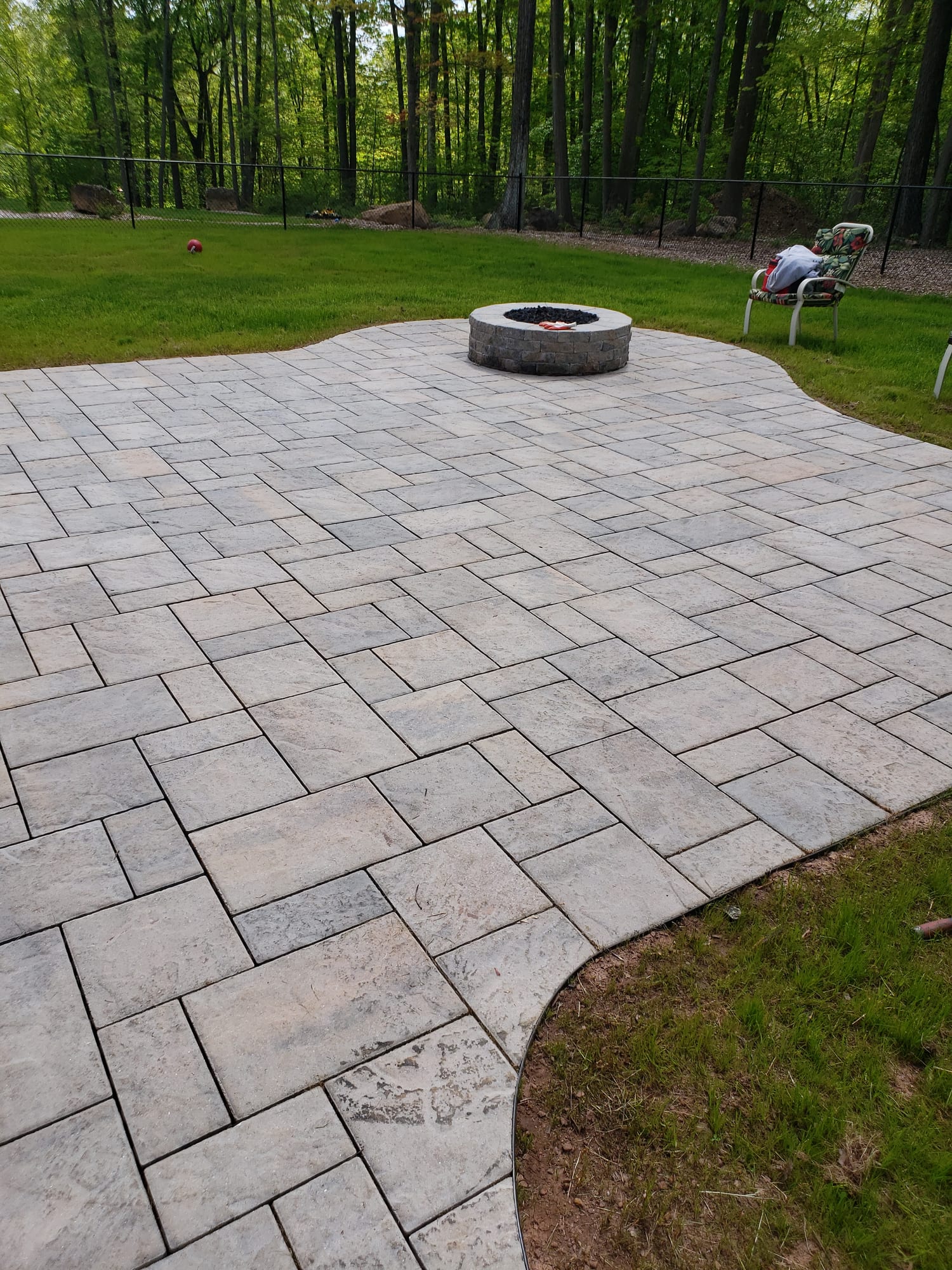 Backyard patio with a round fire pit