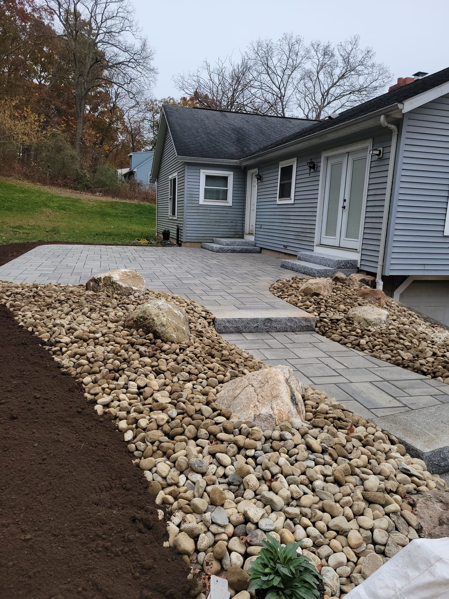 Front walkway between two river-rock beds