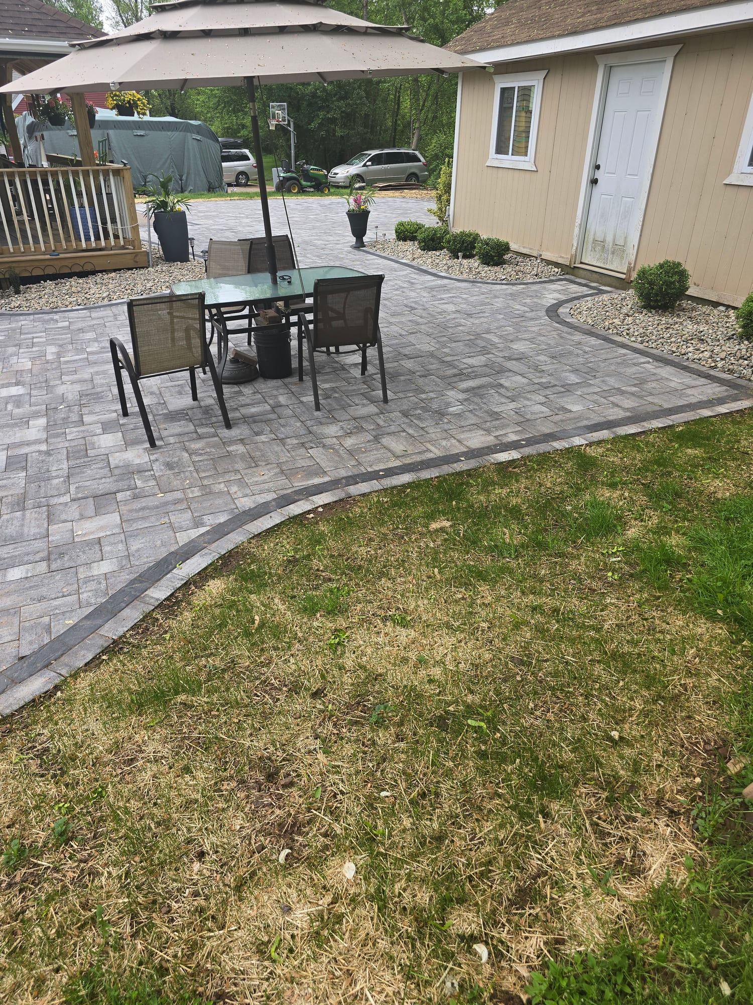 Backyard patio with a dining umbrella
