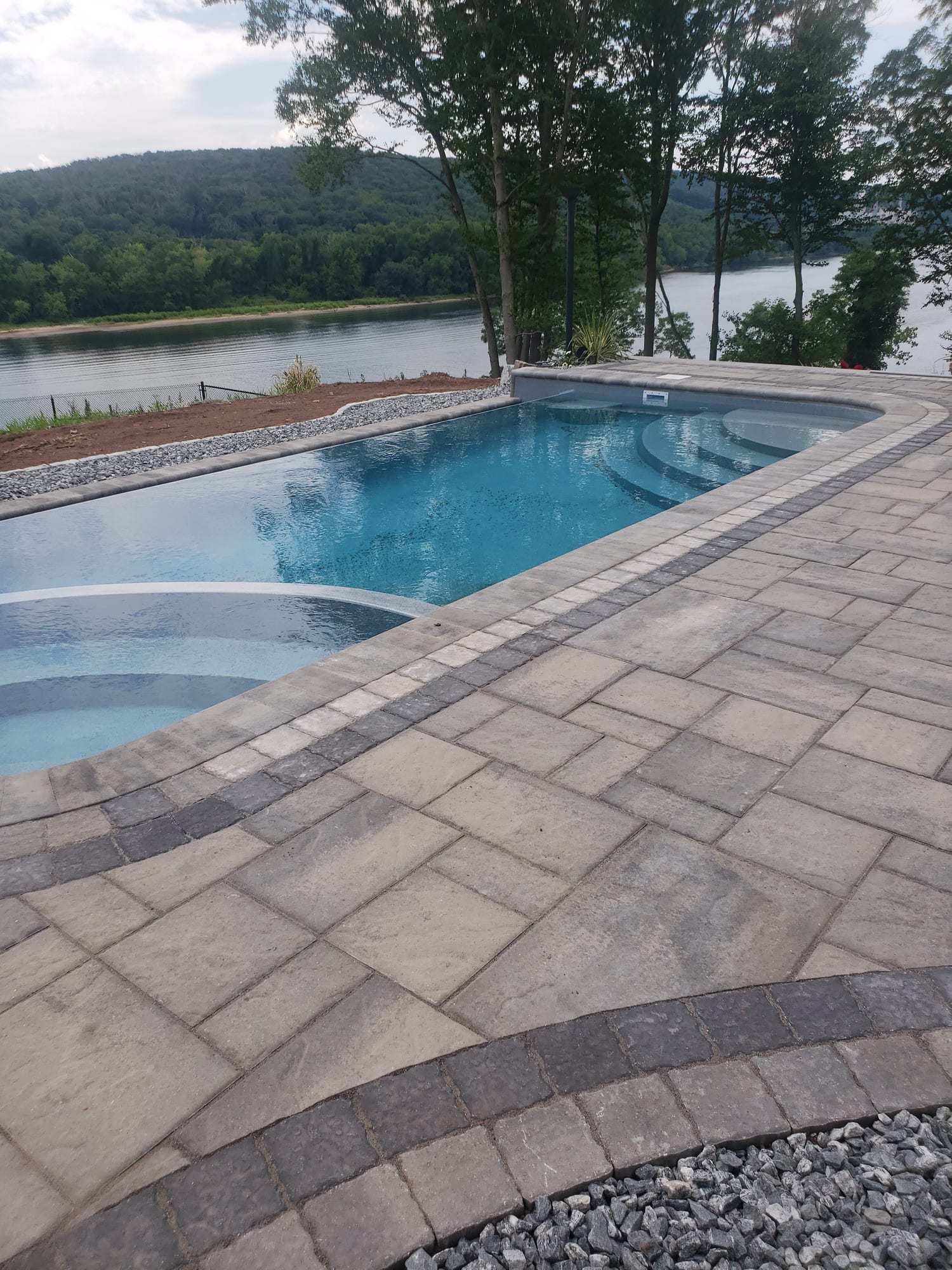 Poolside patio with a curved spa step