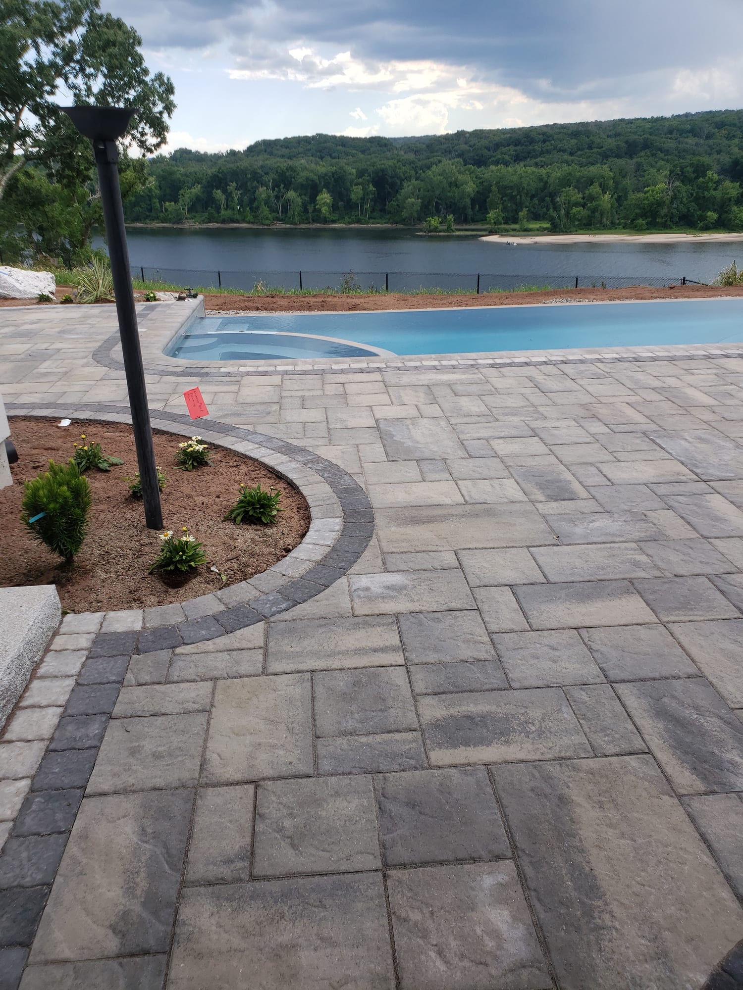 Poolside patio with a river view