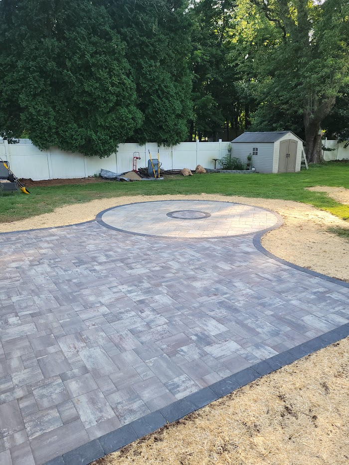Patio with a circular fire pit pad
