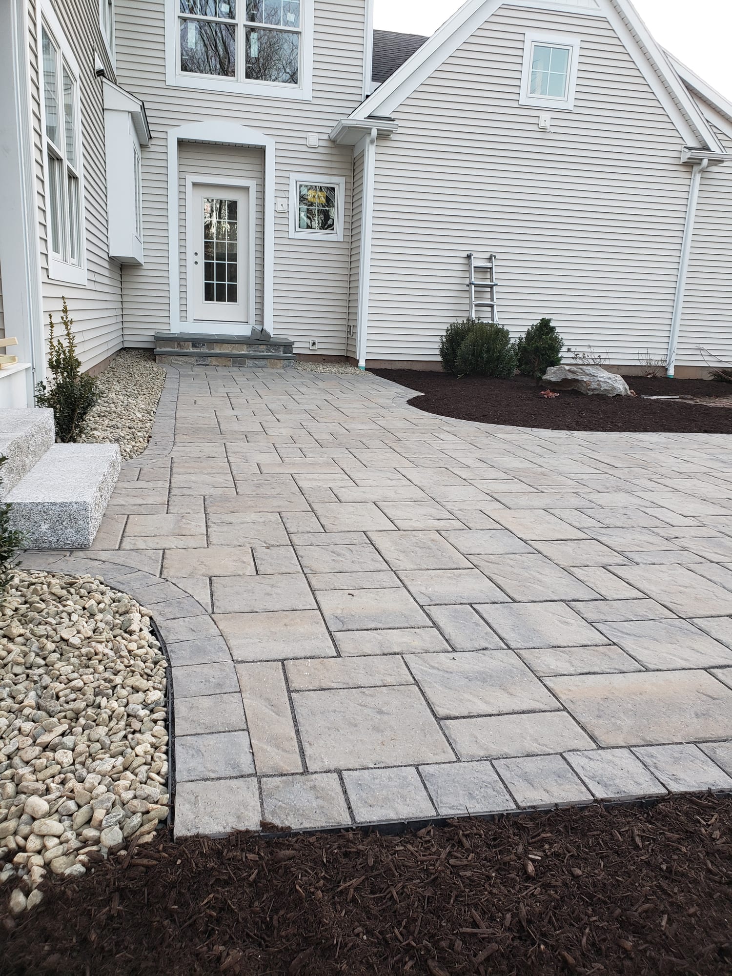 Backyard patio with a granite step landing