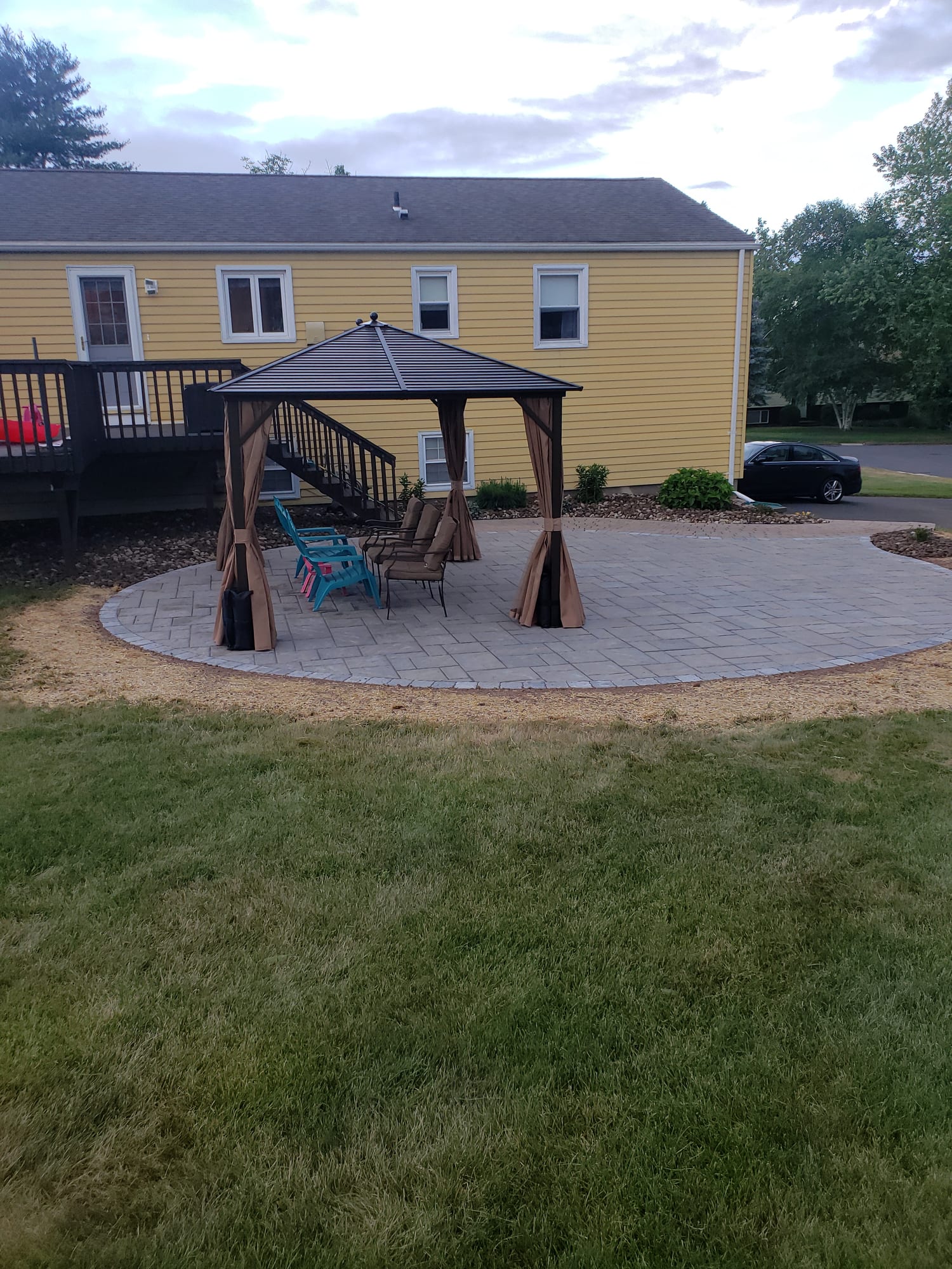 Backyard patio with a curtained gazebo