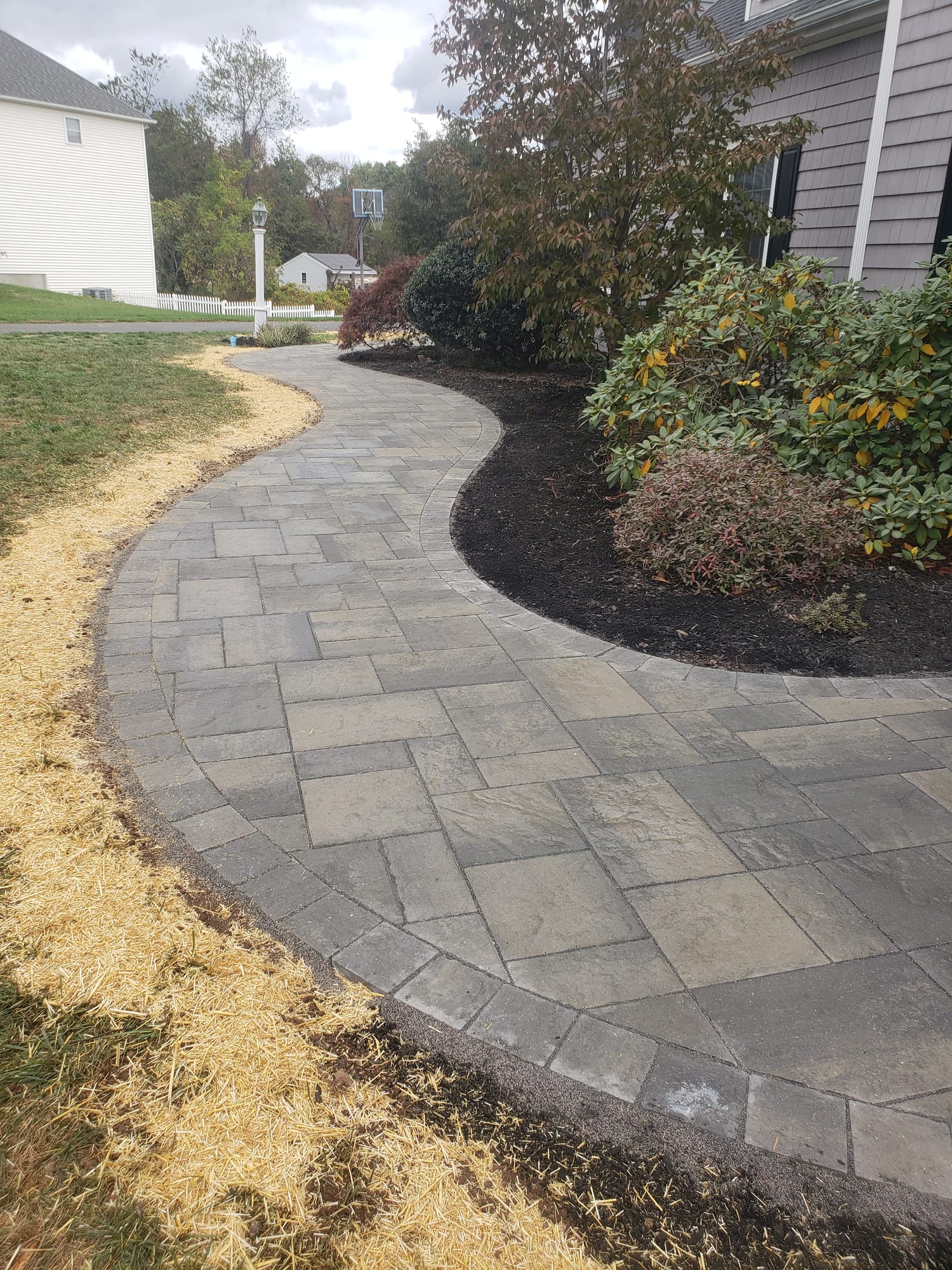 Curving front walkway along a mulch bed